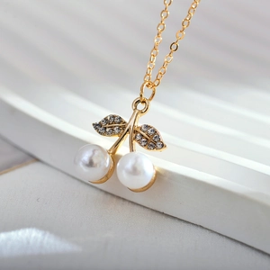 Elegant cherry pendant necklace with two white pearls and sparkling leaf rhinestones