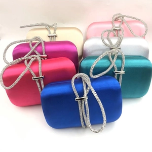 Elegant velvet evening clutch bags with rhinestone handles in multiple colors on white background