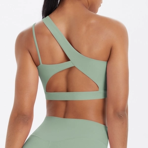 Detail of mint green one-shoulder sports bra with asymmetric cutout back design