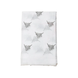 Detail showing white winter scarf with grey highland cow print and delicate frayed edges