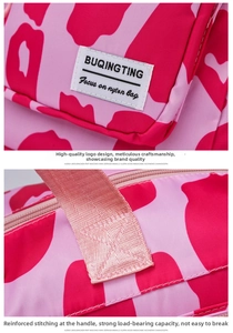 Detail of the reinforced stitching on nylon handles and the brand logo on the gym bag