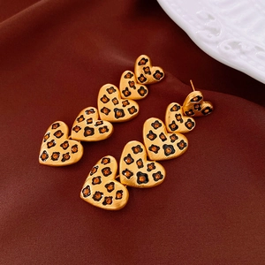 Détail de boucles d'oreilles vintage en forme de cœur avec léopard et strass orange