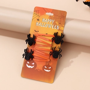 Set of 4 orange Halloween spider hair clips with black glitter on a themed card