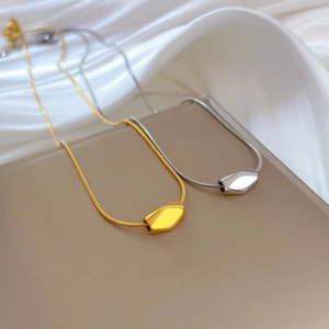 Minimalist gold and silver titanium steel necklaces with irregular geometric pendants on silk