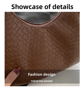 Macro view of brown woven texture and smooth zipper detail on stylish shoulder bag