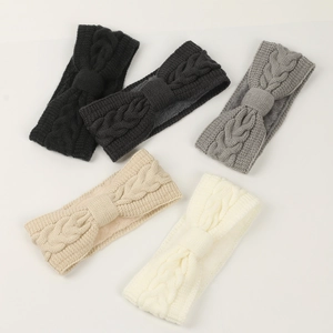 Detailed pile of five cable knit ear warmers with bow design and cozy fleece lining