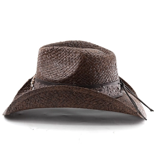 Detail of dark brown straw cowboy hat featuring an embossed band with metal rivets