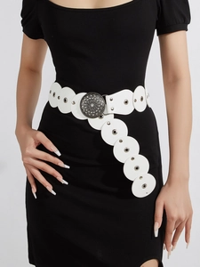 Detail of white western ethnic belt with circular leather patches and vintage carved metal buckle