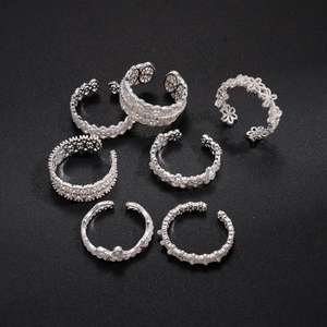 Set of 7 silver hollow floral open rings with intricate lace and geometric details