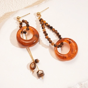 Asymmetric resin tiger eye drop earrings with golden chain in a vintage style
