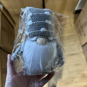 Detailed view of plush Christmas gnome doll featuring a grey knitted hat and white beard