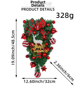 Detail of teardrop Christmas swag with white reindeer, red bow and golden Merry Christmas sign