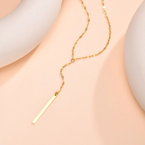 Detailed close-up of a gold-plated stainless steel bar pendant necklace with sleek Y-chain