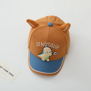 Detail of cartoon dinosaur embroidery on ginger cotton canvas children baseball cap