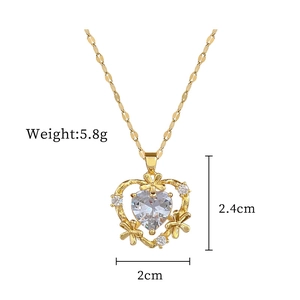 Macro view of gold-plated heart pendant with white zircon showing 2.4cm x 2cm dimensions