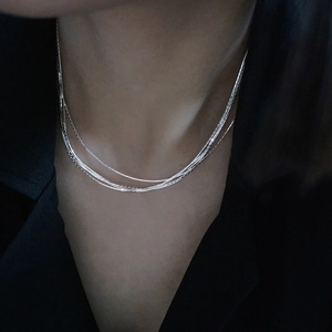 Minimalist multi-layer silver stainless steel necklace shown on a model neck
