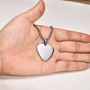 Polished silver guitar pick pendant necklace with twist chain held in a palm