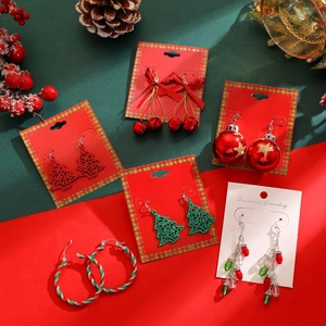 Set of 6 assorted Christmas earrings including glitter trees and red bells on festive background