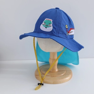 Detail of blue sun hat with embroidered cartoon train and adjustable drawstring