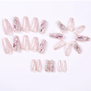 Pink glitter press-on nails set with rhinestones and pearls in ballerina shape