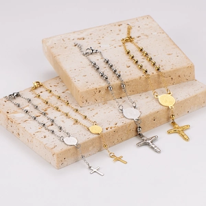 18k gold plated stainless steel bracelet with cross and circular saint medallion charms