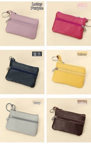 Detail view of colorful lychee grain leather mini pouches with double zipper and key ring