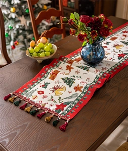 Close-up of Christmas table runner with woven holiday patterns and fringe details