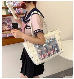 White ita bag with clear display window and bow details shown on a JK uniform model