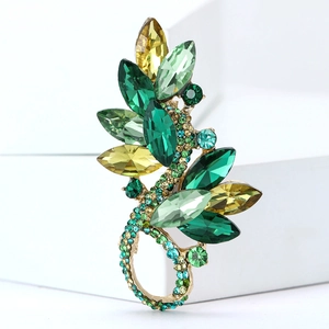 Detailed macro view of an elegant leaf-shaped crystal brooch on a white stand