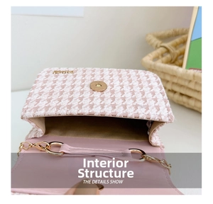 Detail view of pink houndstooth mini bag with magnetic clasp and gold chain strap