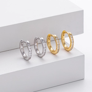 Detailed macro view of gold and silver hoop earrings with micro-pave cubic zirconia crystals