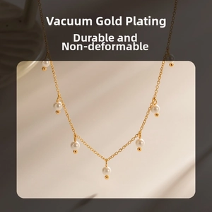 Detail of vacuum gold-plated necklace with seven polished white pearls on fine chain