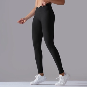 Detail view of high waisted black yoga leggings with seamless V-cross waistband design