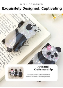 Macro detail of a panda hair claw clip made from high-quality acetate with marble texture