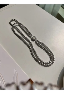 Detail of grey glass pearl double layer necklace with micro-set square shell clasp