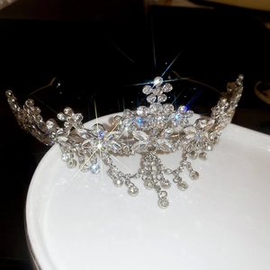 Detail of silver floral crown with sparkling rhinestones and elegant hanging tassels