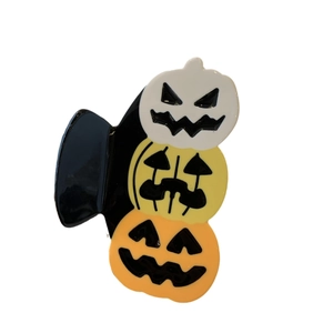 Halloween pumpkin hair claw clip with triple orange jack-o-lantern design in glossy acrylic