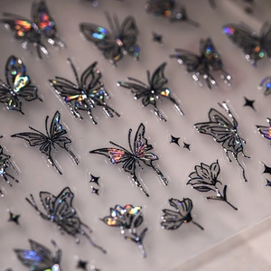 Holographic butterfly and star nail art stickers with metallic gold accents for manicure