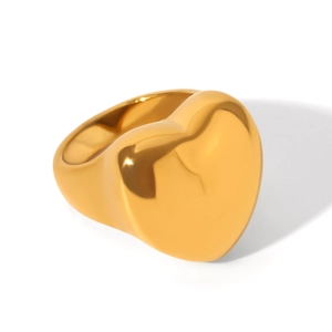 Macro view of chunky heart-shaped signet ring in polished golden stainless steel