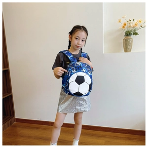 Kid's blue camouflage backpack with 3D soccer ball pocket worn by a model in a home setting