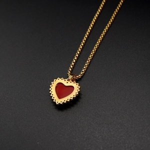 Detailed close-up of 18K gold stainless steel necklace with red heart zircon pendant