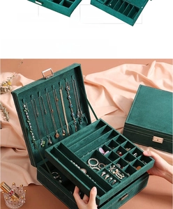 Detail view of emerald green suede jewelry box with 20 earring hooks and 9 ring slots