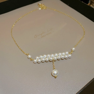 Elegant double-layered faux pearl necklace with gold chain and central pendant drop