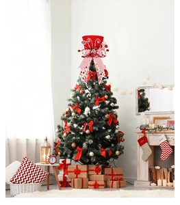 Close-up of red Christmas tree topper hat with bow and festive candy cane detail