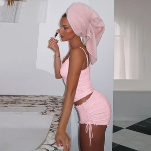 Pink two-piece loungewear set with camisole and drawstring shorts in soft knit fabric