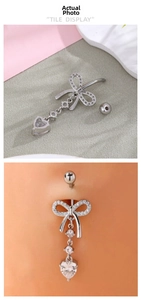 Detail showing a silver bow belly ring with zircon heart pendant and wearable display