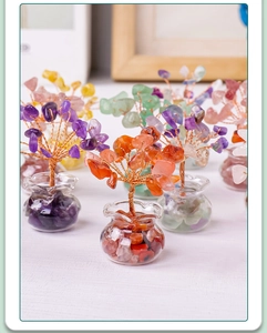 Detail shot of a handmade orange crystal tree with copper wire and glass jar base