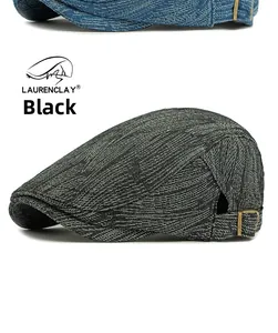 Detailed view of black denim beret with vintage metal side buckle and twill texture