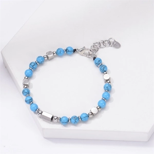 Adjustable turquoise beaded bracelet with square stainless steel accents on white stand