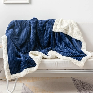 Detail of navy blue ribbed flannel and soft white sherpa fleece double layer blanket